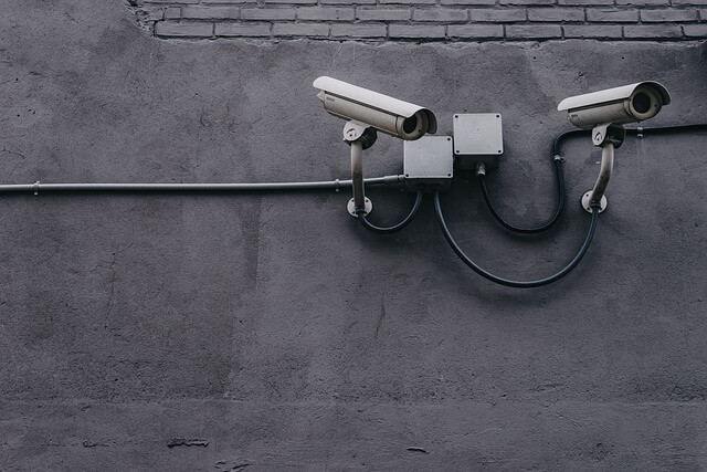Two CCTV cameras installed on a concrete wall